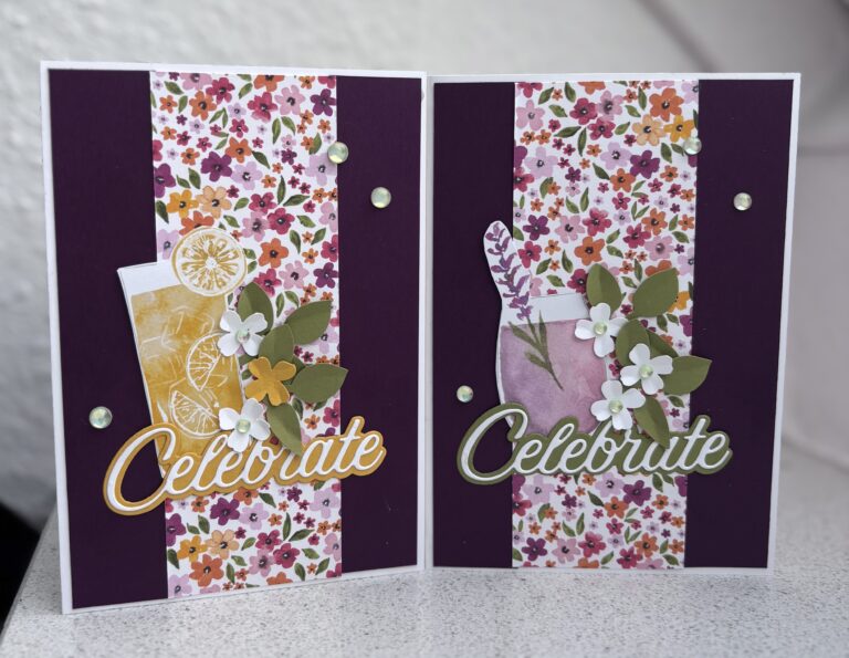 Zwei Grußkarten mit „Celebrate“-Text, floralen Mustern, kleinen Papierblumen und Getränkeillustrationen liegen nebeneinander auf einer hellen Oberfläche – perfekt für Mach was draus Mai 25-Projekte oder festliche Anlässe.