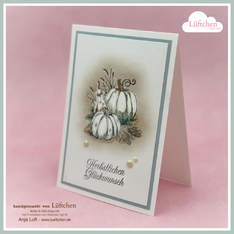 Eine handgefertigte Grußkarte zeigt eine Zeichnung von weißen Kürbissen mit Blättern, den Text "Herbstlichen Glückwunsch" und dekorative Perlen auf einem weiß-grauen Hintergrund - perfekt für eine besondere Herbst 25 Feier.