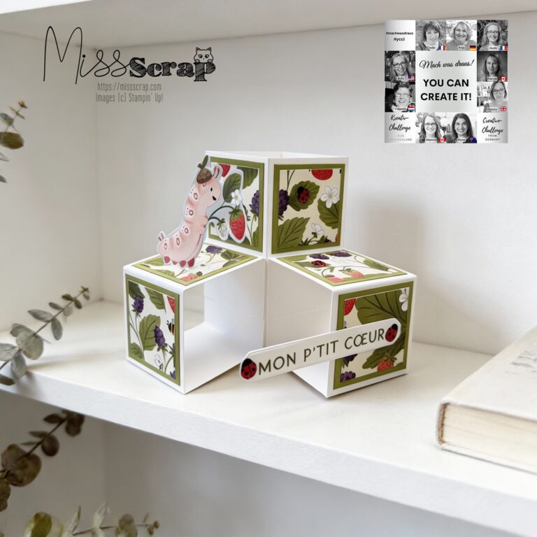 Eine handgemachte 3D-Papierkarte mit Blumenmotiven, einer rosa Wurm-Illustration und einem "Mon P'tit Coeur"-Banner liegt auf einem weißen Regal - perfekt für Mach was draus 26. Februar Kreativität.