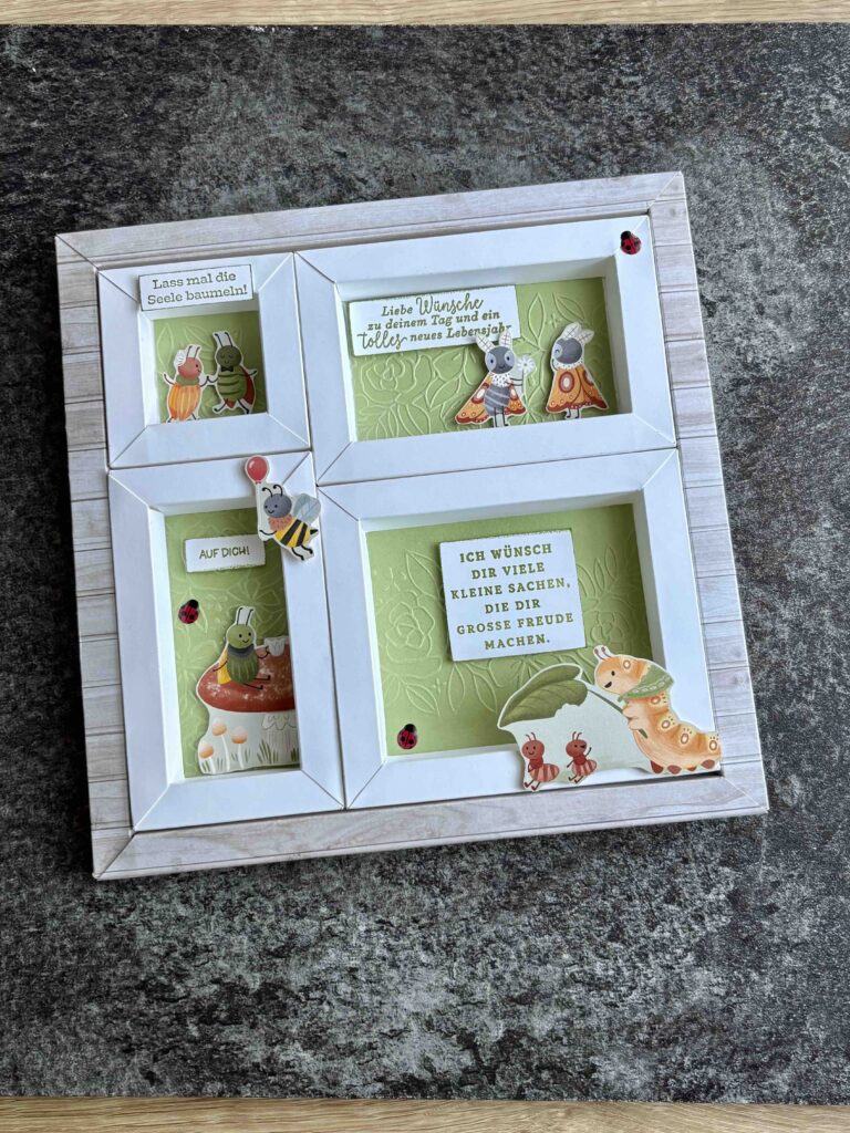 Eine handgefertigte Karte mit geschichteten Rahmen, auf der Cartoon-Tiere, deutscher Text und dekorative Marienkäfer auf einer strukturierten Oberfläche zu sehen sind, wurde am 26. Februar für Mach erstellt.